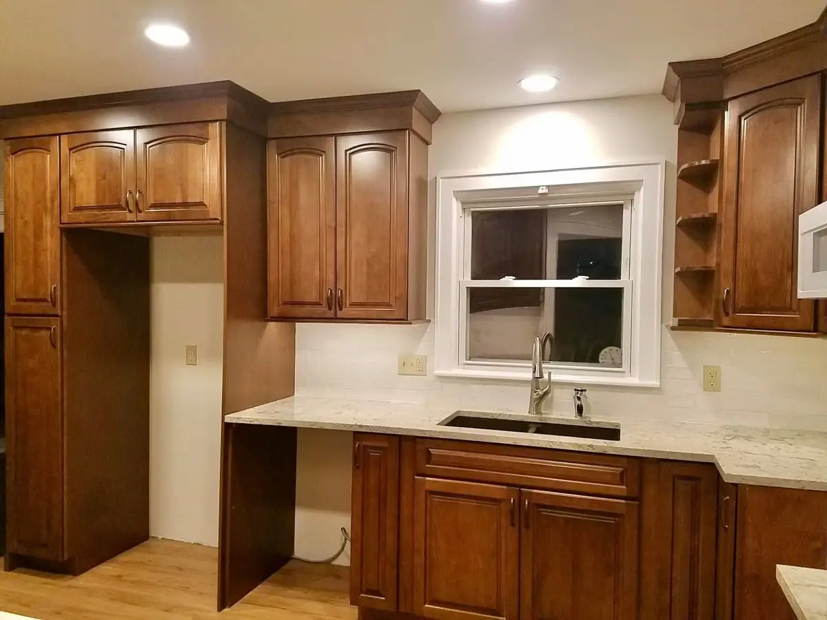 Warm wood kitchen cabinets with a light stone countertop